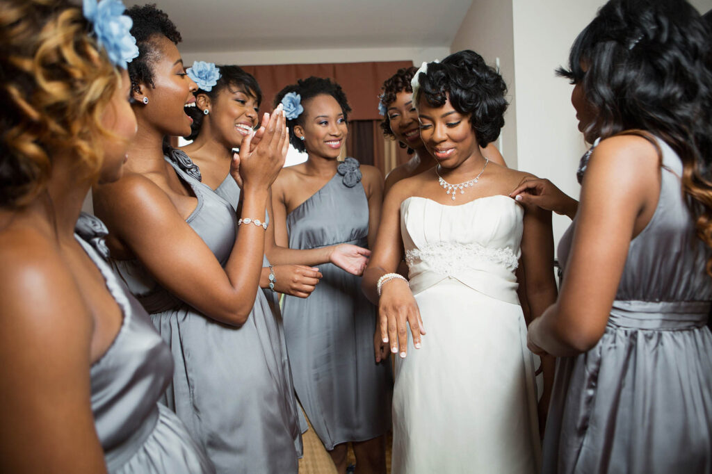Bride and brides maids getting dressed.